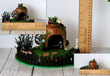 Miniature fairy garden house in tea cup room inside. Led light handmade