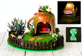 Miniature fairy garden house in tea cup room inside. Led light handmade