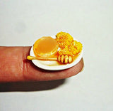 Plate with honey and honeycomb. Dollhouse miniature 1:12
