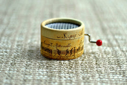 Music Box decorated with music writting with the song La vie en Rose in a hand cranked mechanisms
